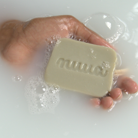 Hand in water with nuud's refresh bar