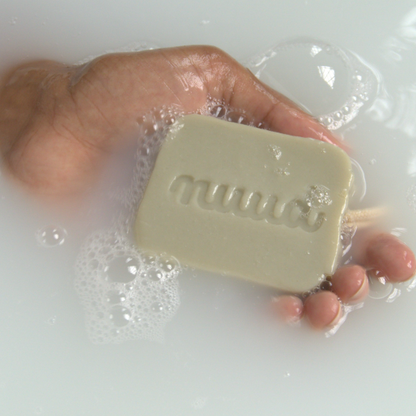 Hand in water with nuud's refresh bar