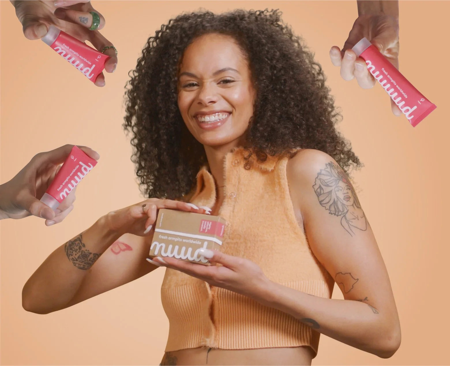 Someone opening a nuud box, with hands passing tubes around her
